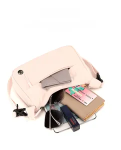 Detail view of pink lightweight canvas crossbody bag showing spacious inner storage