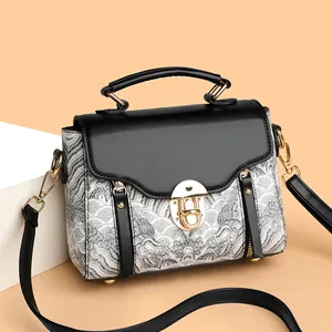Retro crossbody bag with wave pattern and gold metal lock shown in a 45-degree angle