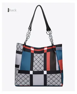 Detailed back view of a large nylon tote bag with colorful geometric patchwork design