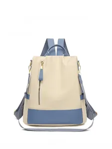 Vue détaillée du sac à dos antivol beige et bleu avec poche zippée verticale pratique