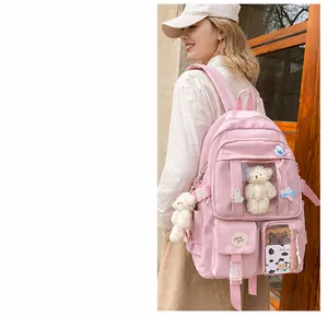 Mochila rosa para estudiantes con múltiples bolsillos, ventana frontal y oso peluche