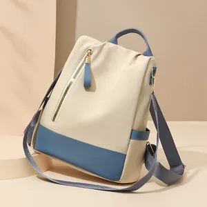 Sac à dos antivol chic beige et bleu avec garniture en cuir et sangles