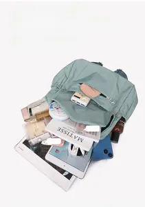 Top view of a light green nylon backpack showing large capacity for iPad and A4 magazines