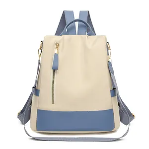 Sac à dos antivol beige pour femme avec bretelles bleues et détails de zip doré