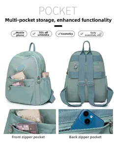 Detail showing multi-pocket storage for phone and umbrella in light green nylon backpack