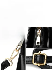 Detailed view of glossy gold-toned hardware and litchi texture on black leather handbag