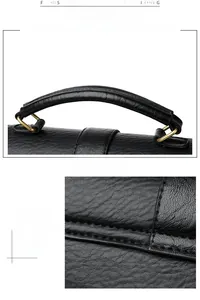 Detail of black pebbled leather handbag with sturdy handle and gold metal hardware