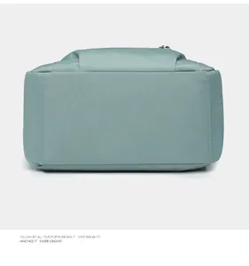 Detail view of the wide base and reinforced stitching of this light blue oxford backpack