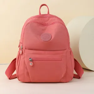 Coral pink Oxford cloth backpack for women with front zipper pocket and side water bottle holder