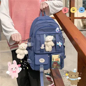 Blauer Oxford-Schulrucksack mit süßem Bärenanhänger und dekorativen Cartoon-Ansteckern