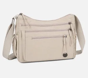 Detail of the multi-zipper compartments and adjustable strap on the nylon crossbody bag