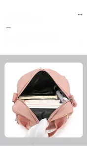 Pink nylon shoulder bag interior showing large capacity compartments and internal pockets