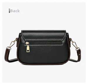 Detail view of the back pocket and white contrast stitching on a black crossbody bag