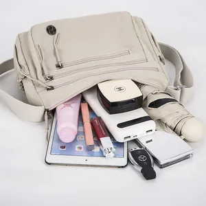 Waterproof nylon crossbody bag in beige with large capacity for travel and daily essentials