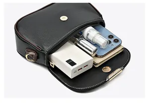 Top view of the interior compartment showing capacity for phone and cosmetics