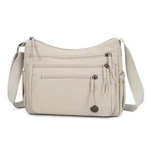 Light khaki nylon crossbody bag with multi-layer zipper pockets and adjustable strap