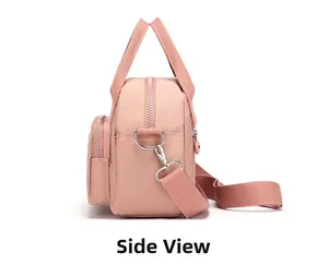 Side view of pink nylon crossbody bag with silver hardware and durable shoulder strap