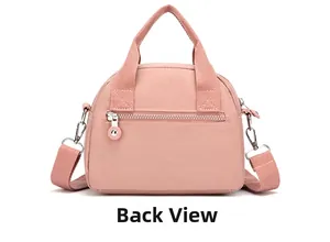 Detailed back view of pink nylon crossbody bag showing the functional rear zipper pocket