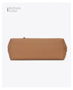 Detailed view of the flat bottom and reinforced stitching on a brown tote shoulder bag