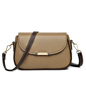 Taupe pebbled leather crossbody bag with contrast stitching and metallic buckle detail