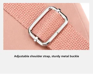 Detail of pink nylon shoulder strap with adjustable silver metal buckle and woven texture