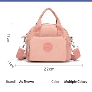 Pink nylon crossbody bag for women with dual handles and dimensions of 22x17x11cm