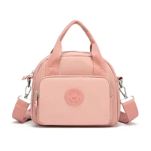 Pink waterproof nylon shoulder bag with multi-layer zipper pockets and adjustable strap