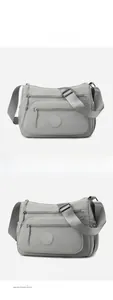 Close-up of waterproof grey nylon crossbody bag with multi-pocket design and woven strap