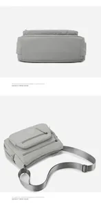 Detail showing multi-zipper compartments and water-resistant nylon texture of gray crossbody bag