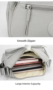 Detail view of smooth metal zippers and large internal capacity of gray nylon crossbody bag