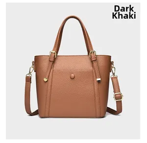 Detailed view of dark khaki tote bag in pebble grain leather with gold hardware