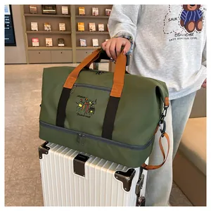 Detail of travel duffel bag with bottom wet-dry compartment on a suitcase handle