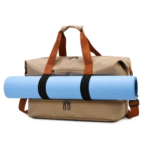 Khaki travel bag with orange straps and blue yoga mat carrier on a white background