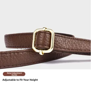 Detail of lychee pattern leather strap with gold adjustable buckle on dark brown tote bag