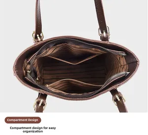 Detail view of the brown leather tote bag interior with striped lining and compartments