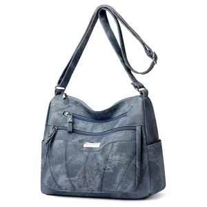 Navy blue multi-pocket crossbody bag with adjustable strap and textured leather finish