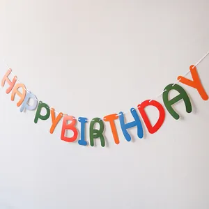 Colorful felt Happy Birthday banner hanging on a white background for party decoration