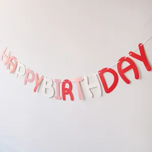 Detail of pink and white Happy Birthday banner hanging on wall for party decor