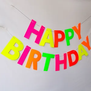 Detailed view of neon HAPPY BIRTHDAY banner with vibrant fluorescent matte cardstock letters