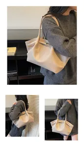 Detail of beige large tote bag showing soft lychee grain texture and gold buckle