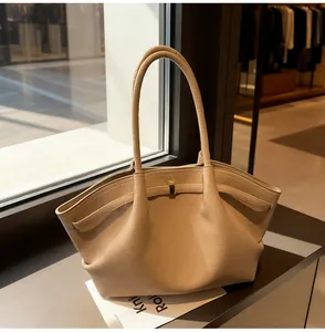 Detailed macro view of beige lychee grain leather tote with elegant pleated folds and long handles
