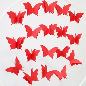 Detailed view of 3D red paper butterfly garland hanging from a white circular frame