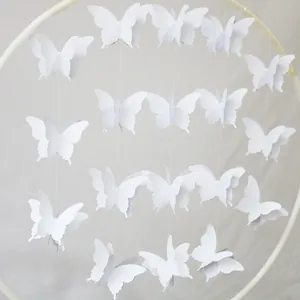 Detail view of 3D white paper butterfly garland hanging decor for party setting