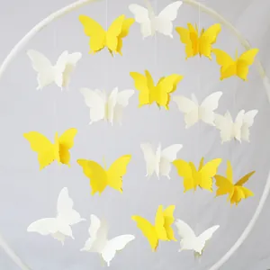 Hanging 3D colorful butterfly paper garlands in yellow and white for party decoration