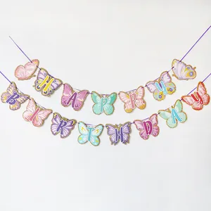 Close-up of Happy Birthday butterfly banner with glitter edges and macaron colors
