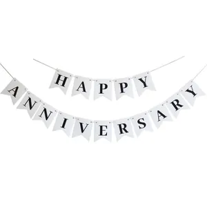 Detail of white swallowtail banner with black Happy Anniversary lettering and white string