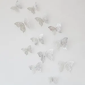 Detailed 3D hollow butterfly wall stickers in silver metallic finish on a white background