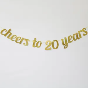 Detail of gold glitter 'Cheers to 20 years' banner for birthday or anniversary party decor
