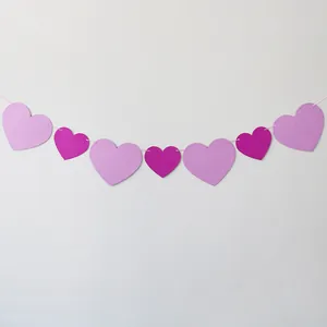 Glittery heart garland with pink and purple paper hearts for romantic party wall decor