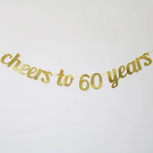 Detail of glittery gold 'Cheers to 60 Years' banner for anniversary party decoration